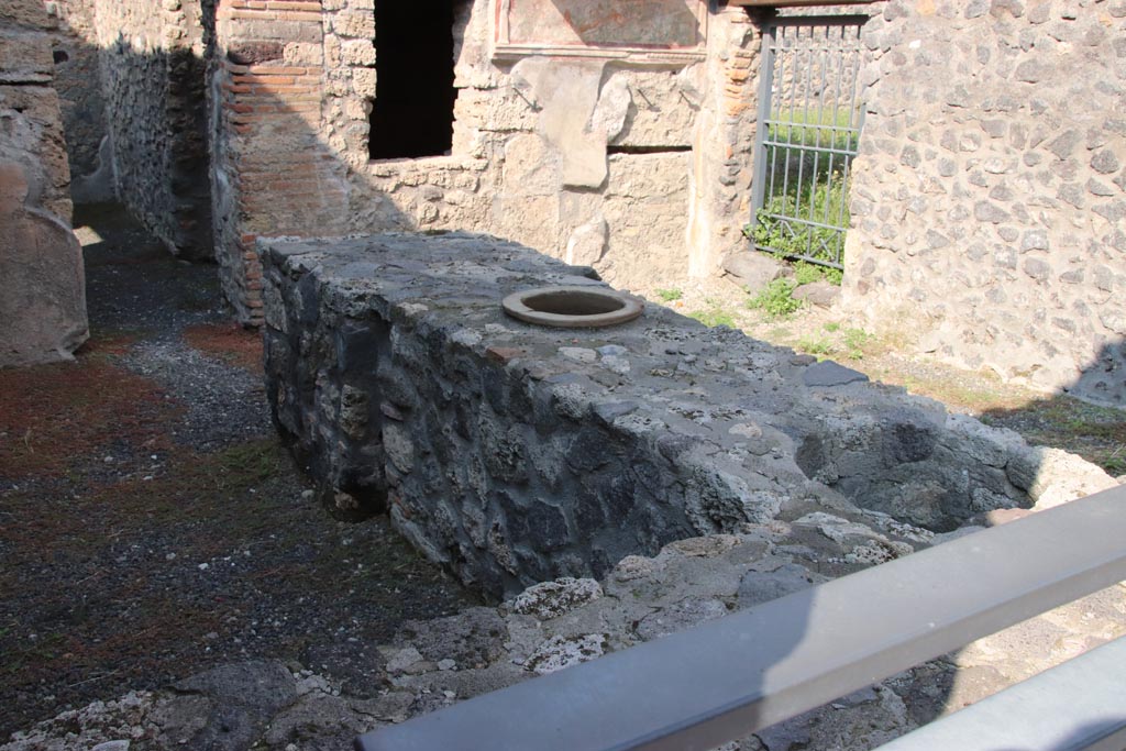 I.11.11 Pompeii. October 2022. Looking north-east across counter in bar-room. Photo courtesy of Klaus Heese.