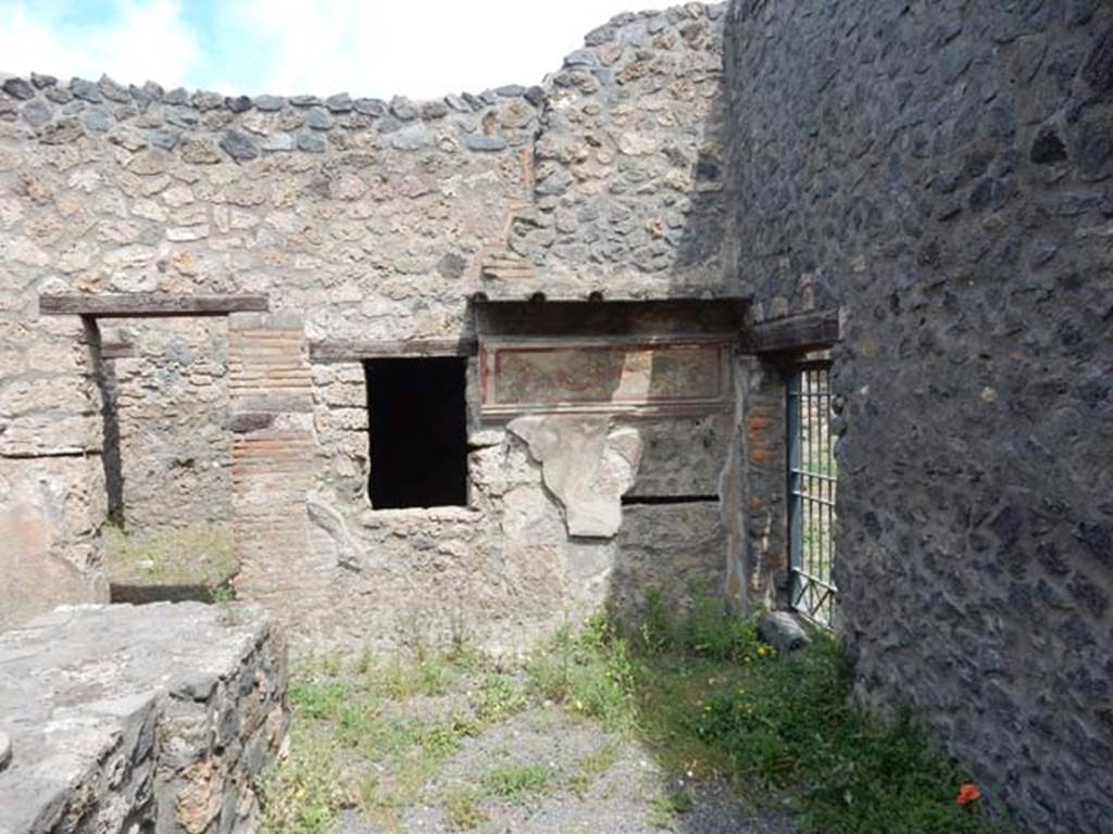 I.11.11 Pompeii. May 2017. Looking north across bar-room with painted lararium on east side (right) of north wall. Photo courtesy of Buzz Ferebee.
