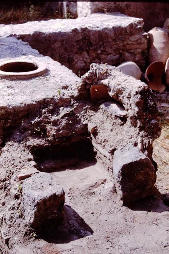 I.11.11 Pompeii. 1964. Rear of counter and hearth.  Photo by Stanley A. Jashemski.
Source: The Wilhelmina and Stanley A. Jashemski archive in the University of Maryland Library, Special Collections (See collection page) and made available under the Creative Commons Attribution-Non Commercial License v.4. See Licence and use details.
J64f1798
