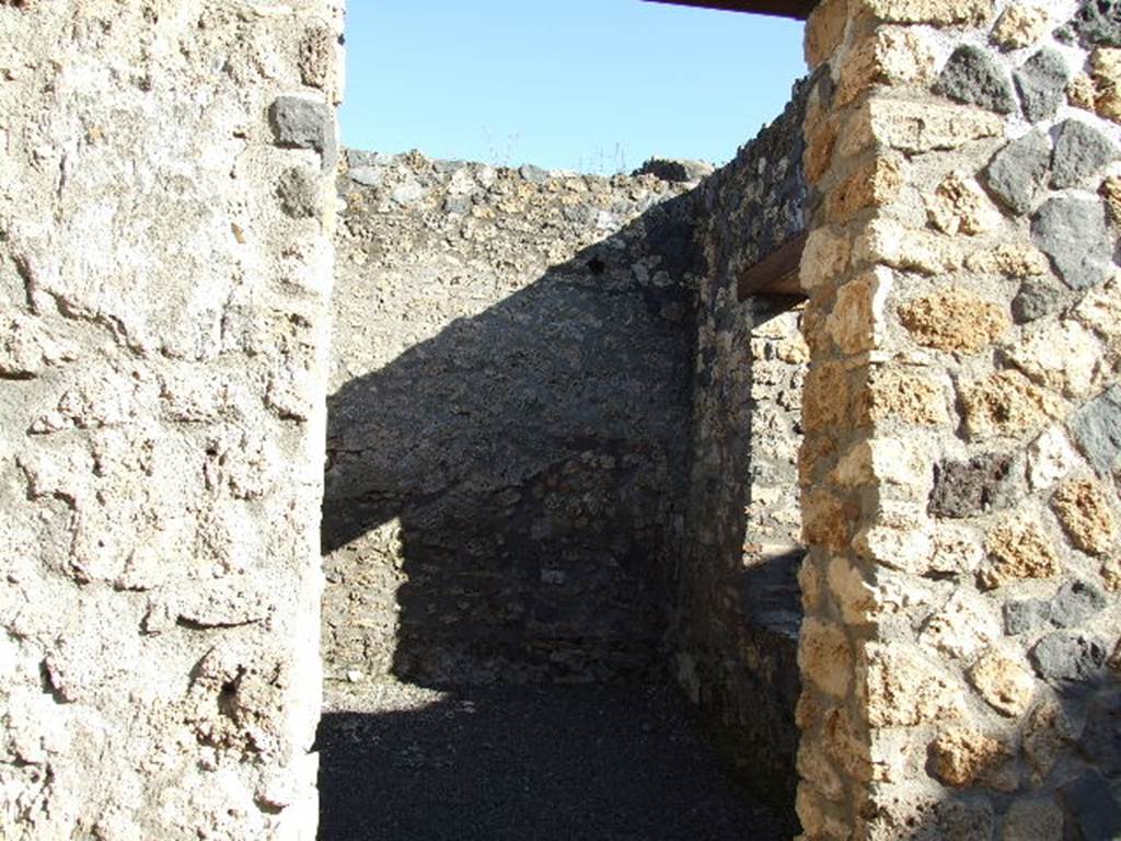 I.11.13 Pompeii. December 2006. Doorway to room on north-east side of atrium, with window onto west portico.