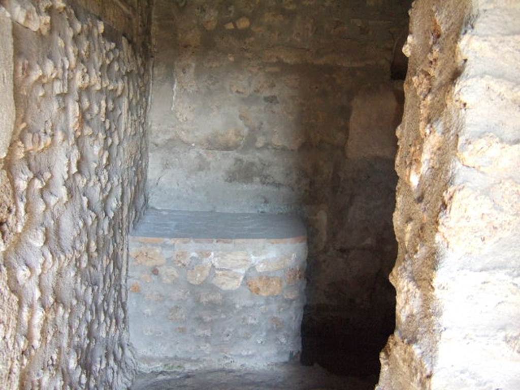 I.11.14 Pompeii. September 2005. Looking north into kitchen, with the lararium niche on the wall on east side of the bench.
