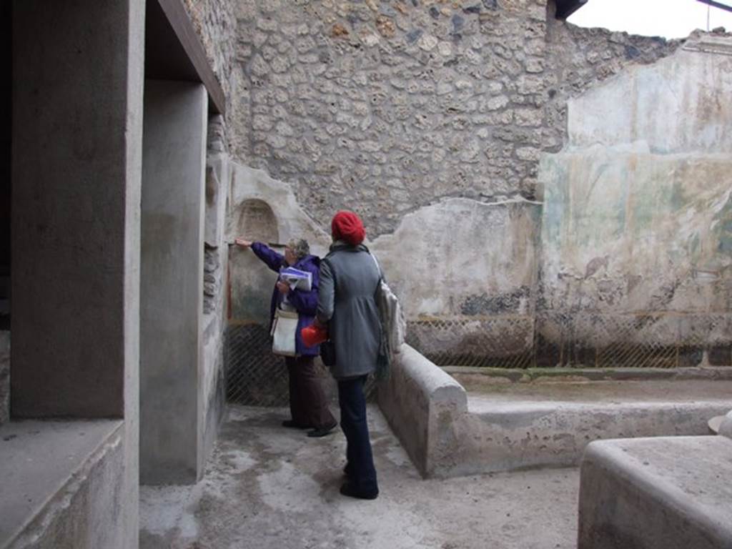 I.11.16 Pompeii. December 2007. Room 6, looking north towards triclinium and two niches.  
The walls are painted with style IV garden scenes, with a black dado divided by yellow lines into a trellis pattern, and set off by a yellow border.

