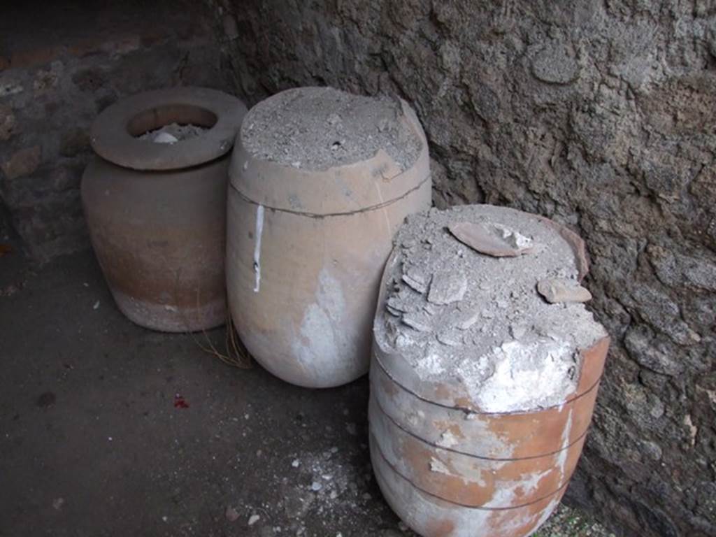 I.11.17 Pompeii. December 2007. Room 5, terracotta pots in north-east corner of small garden area by entrance to kitchen.
