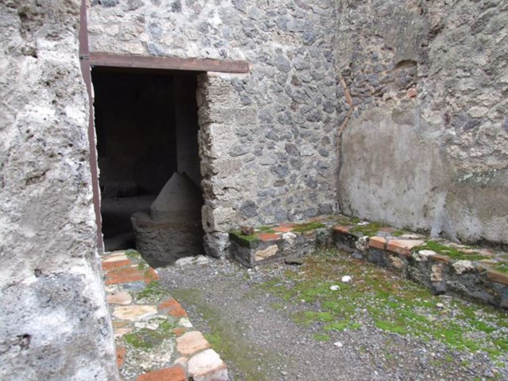 I.12.1 and I.12.2 Pompeii. December 2006. Room 1, benches. Looking east to doorway to bakery in room 3.