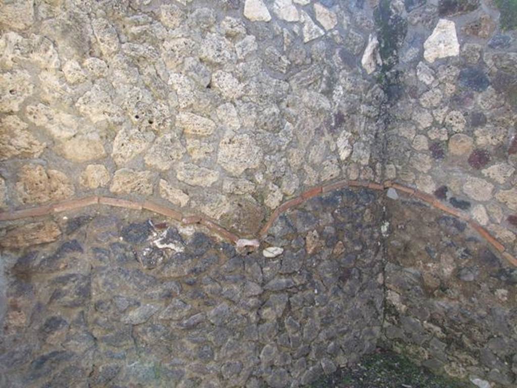 I.12.2 and I.12.1 Pompeii.  March 2009.  Room 5.  South east corner and east wall.  The original walls are below the line made from terracotta tiles, above is restored and rebuilt.