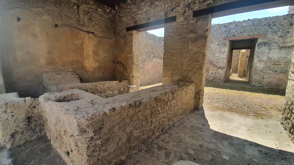 I.12.5 Pompeii. August 2021. 
Looking towards east wall, and counter with shelving for displaying drinking vessels. Photo courtesy of Robert Hanson.
