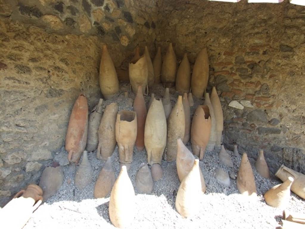 I.12.8 Pompeii. March 2009. Room 13, rear garden with remains of empty amphorae.
According to Curtis, a large number of empty amphorae were excavated especially in the north-east corner where many remain as they were in 79AD, stacked upside down and awaiting re-use. These amphorae came in a variety of sizes and shapes. A few of the amphorae had painted inscriptions relating to their contents, but unfortunately did not show any inscriptions that would permit the identification of the owner of this garum shop. See Curtis R.L: The Garum shop of Pompeii, In Cronache Pompeiane, V.1979, p.13-4 and note 12.
