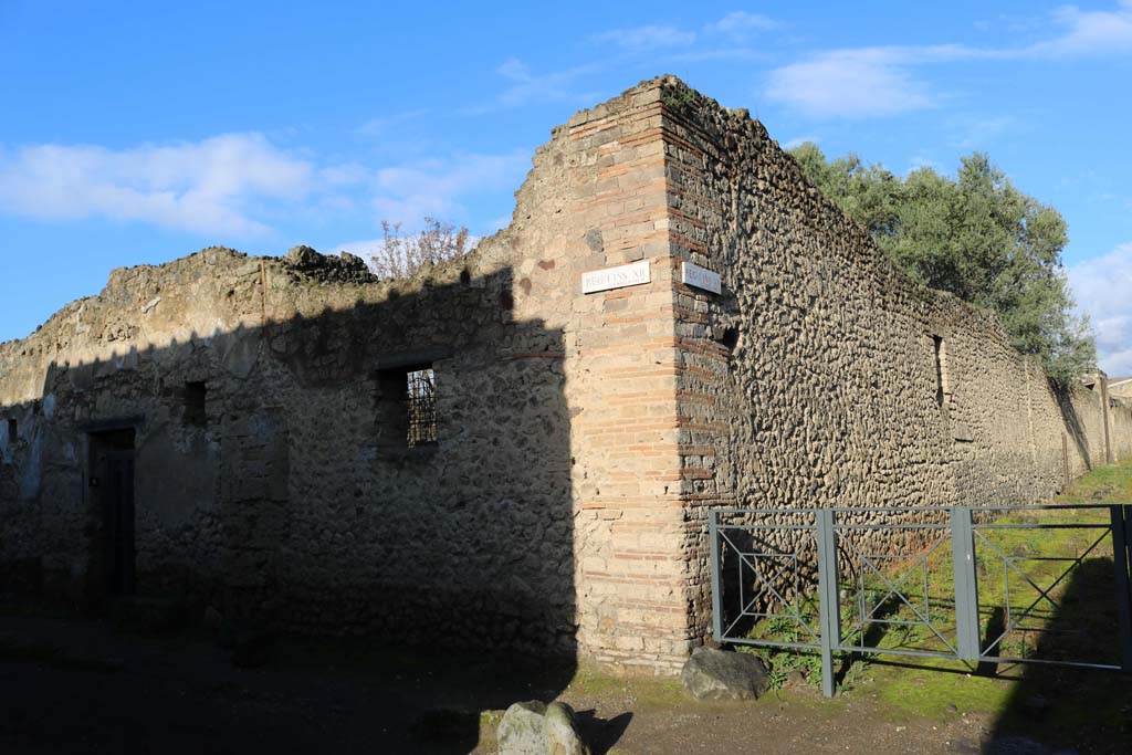 I.12.8 Pompeii. December 2018. 
Looking towards entrance doorway on south-east corner of insula, on north side of Via di Castricio. Photo courtesy of Aude Durand.
