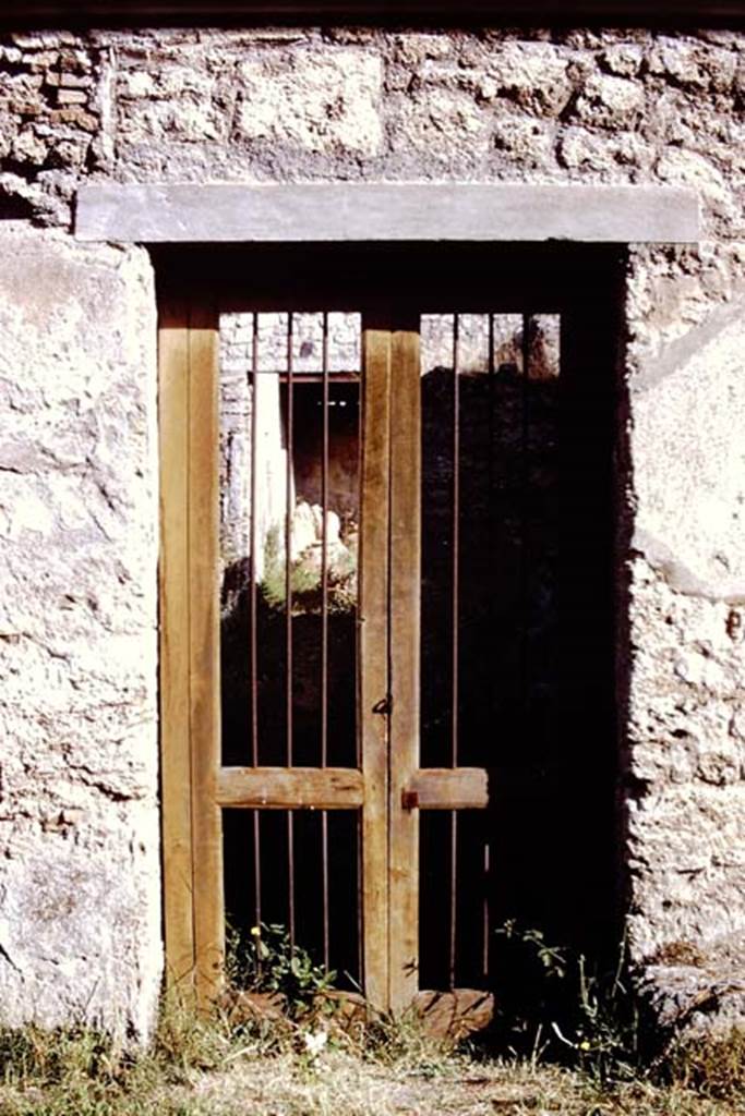 I.12.8 Pompeii. 1972. Looking north through entrance doorway. Photo by Stanley A. Jashemski. 
Source: The Wilhelmina and Stanley A. Jashemski archive in the University of Maryland Library, Special Collections (See collection page) and made available under the Creative Commons Attribution-Non Commercial License v.4. See Licence and use details. J72f0603
