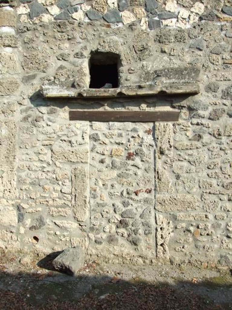 I.12.11 Pompeii. December 2007. 
Blocked doorway, sill and window into small room next to kitchen.   
Looking east from Vicolo della Nave Europa.  
