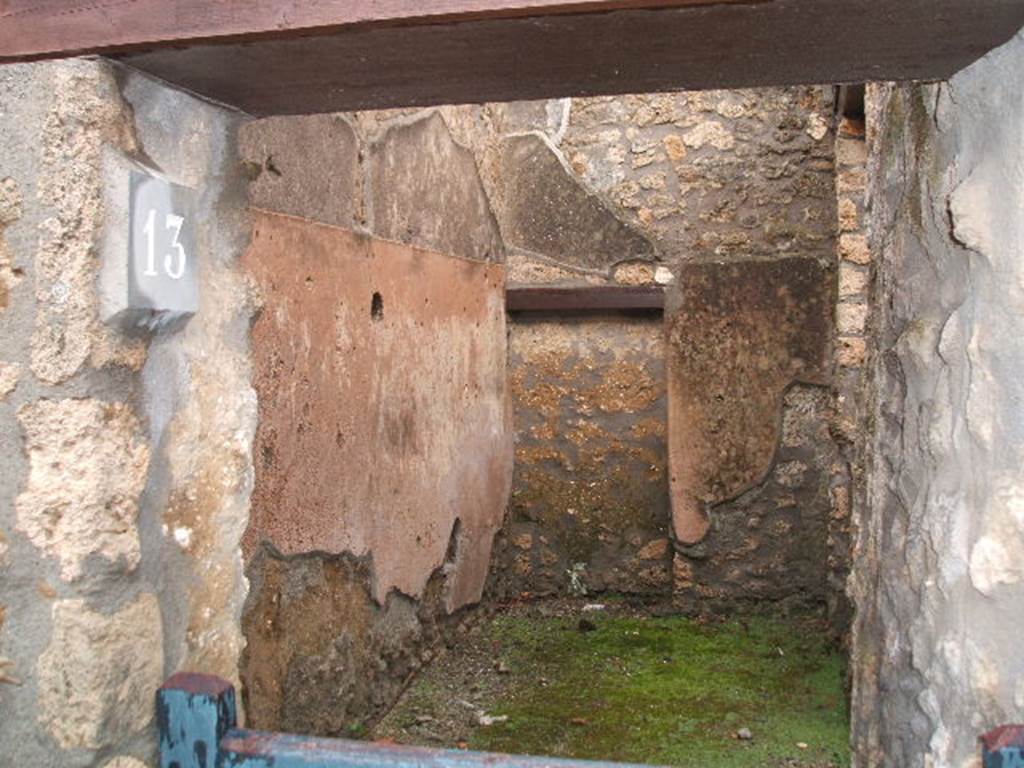 I.12.13 Pompeii. December 2004. Looking east from entrance towards a blocked doorway. This originally would have led into the atrium of I.12.11.
