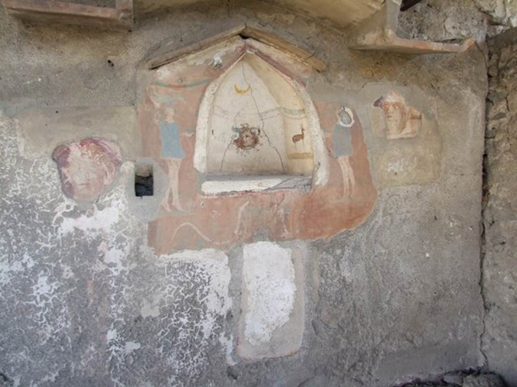 I.12.15 Pompeii.  March 2009.  Room 5.  East wall.  Lararium, with niche, and the remains of faces on either side.  See Frhlich, T., 1991. Lararien und Fassadenbilder in den Vesuvstdten. Mainz: von Zabern. (L27, T:4,1).