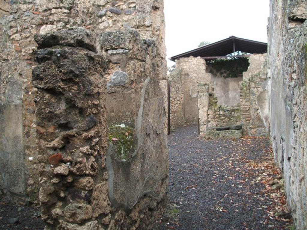 I.12.15 Pompeii. December 2004. Entrance fauces, looking east. The doorway to room 2, a cubiculum is on the left, and the atrium is ahead.
