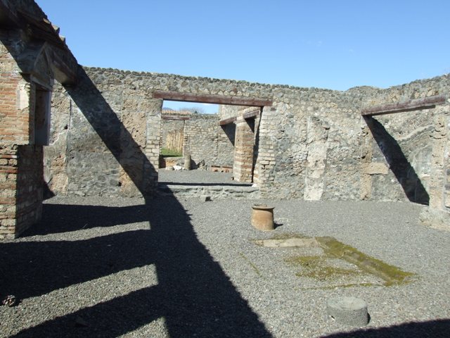 I.13.12 Pompeii. December 2004. West side of atrium, with doorway to steps to upper floor, doorway to Cubiculum, Isis Sacellum, and Ala.