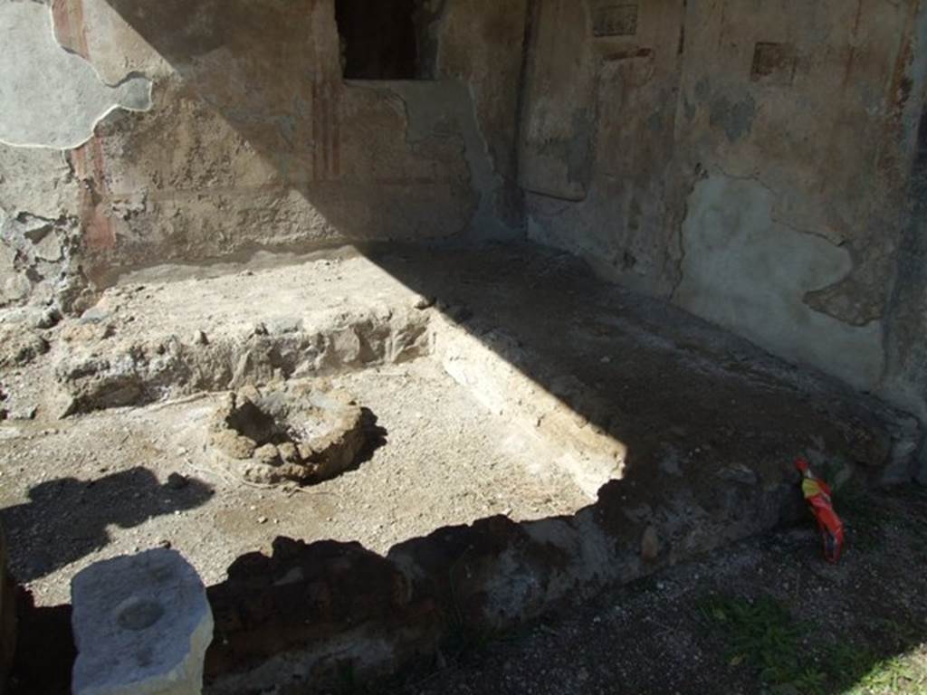 I.13.16 Pompeii. March 2009. Masonry summer triclinium, couches against west and north wall and cistern head used as the table.