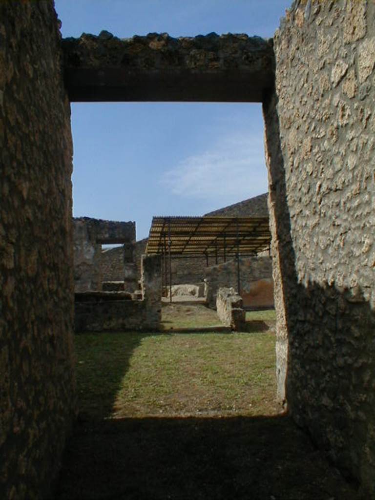 I.14.4 Pompeii. September 2004. Entrance fauces looking west across possible atrium towards garden.