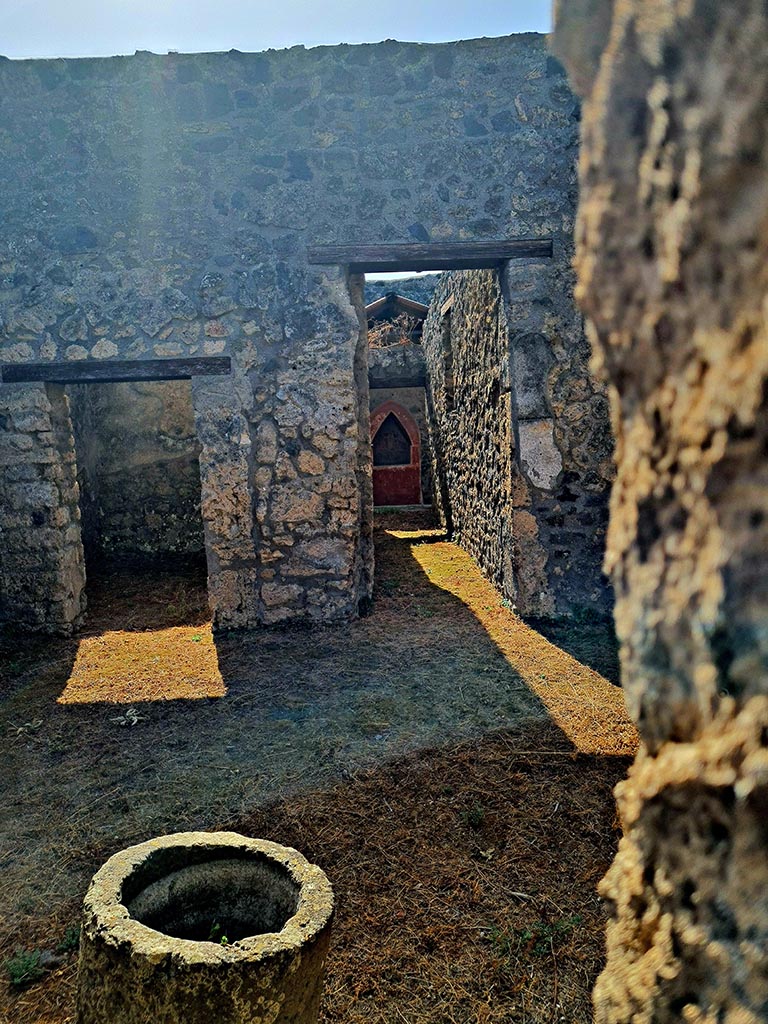 I.14.6/7 Pompeii. September 2024. 
Looking south into atrium of I.14.7 from doorway of shop at I.14.6. Photo courtesy of Giuseppe Ciaramella.
