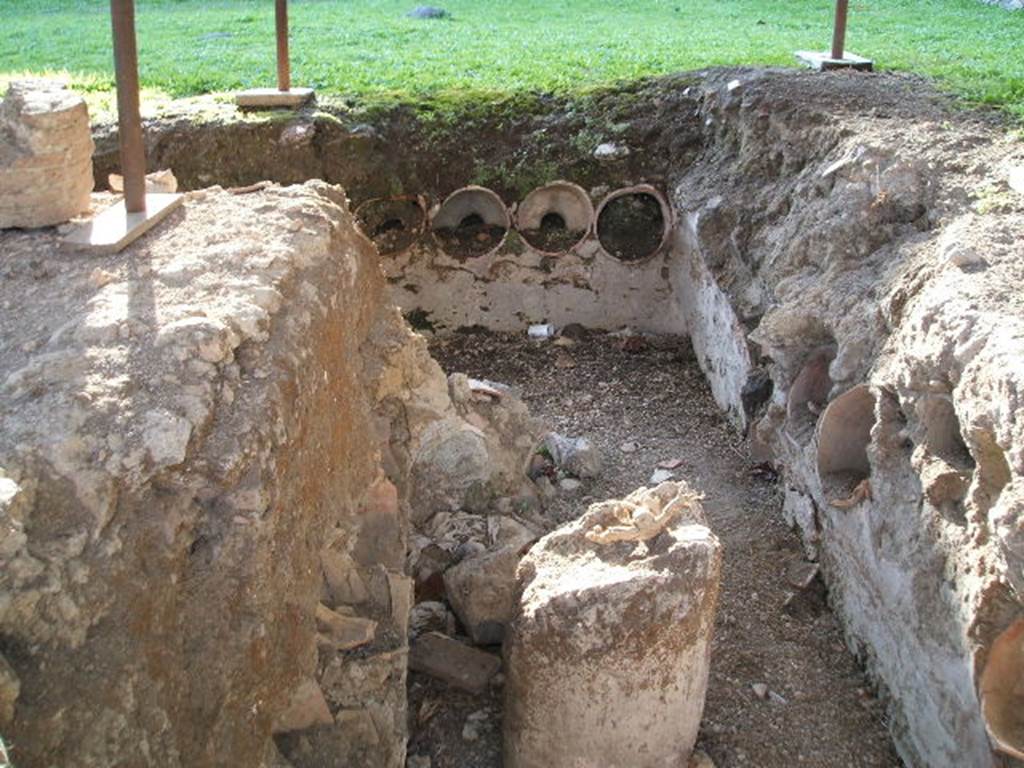 I.14.10 Pompeii. December 2004. Pots in the side of the triclinium.