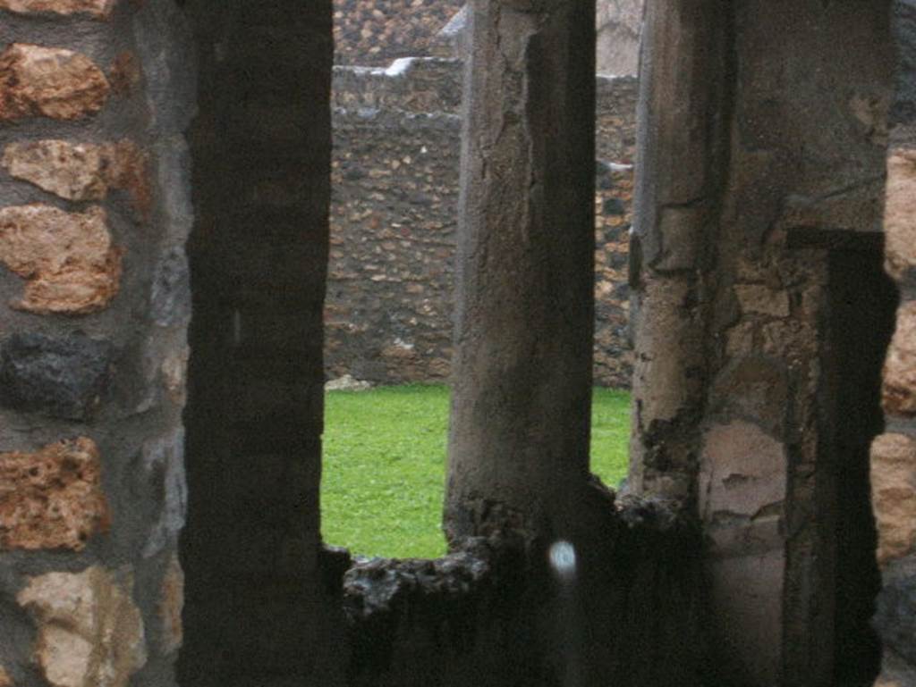 I.14.12 Pompeii. December 2004. Room 34, east portico of peristyle area, looking north, taken from I.14.13