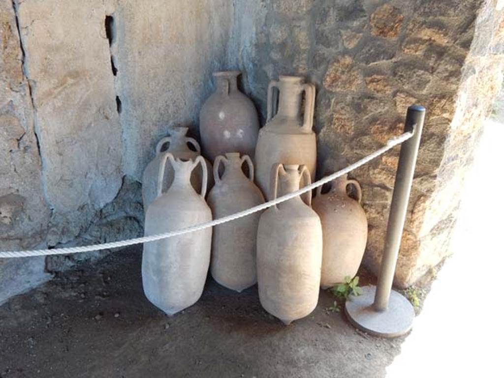 I.14.12, Pompeii. May 2018. Looking towards amphorae standing in south-east corner of room 32, the east portico. Photo courtesy of Buzz Ferebee.
