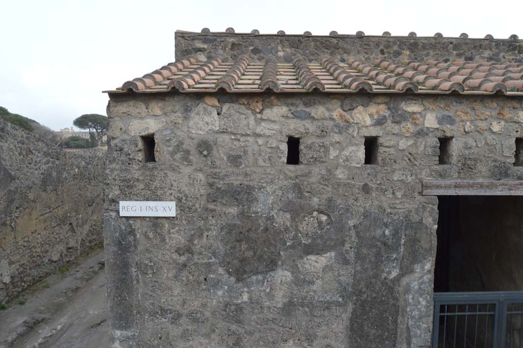 I.15.1 Pompeii. March 2019. 
Looking south to upper area of front façade, at east end of Insula, with Vicolo dei Fuggiaschi, on left.
Foto Taylor Lauritsen, ERC Grant 681269 DÉCOR.
