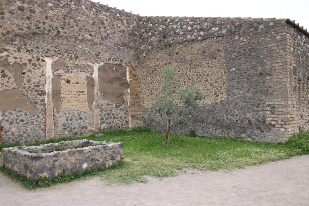 I.15.3 Pompeii. May 2010. Looking south across room 14, garden area.
In the enormous garden at the rear of the houses on the north side of the insula, roots from an orchard, vineyard and vegetable garden were discovered.
According to Laurence a market garden was identified in the south-eastern area of Insula 15. 
Produce included grapes, olives, nuts, fruit and vegetables. These were probably sold elsewhere in the city. 
Similar planting schemes were excavated in the 19th century at VI.6.1 and IX.1.20.”
See Laurence R., 1994. Roman Pompeii: Space and Society. London: Routledge, p. 67.
