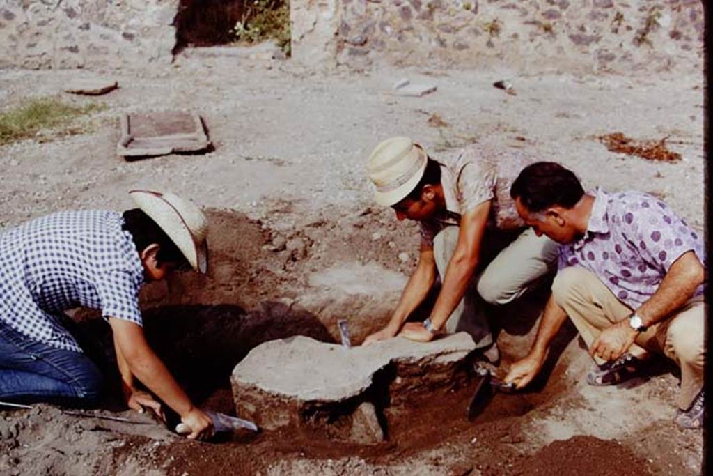 I.15.3 Pompeii, 1973. Digging out a cast of a tree-root, looking east towards doorway at rear of I.15.5/6. Photo by Stanley A. Jashemski. 
Source: The Wilhelmina and Stanley A. Jashemski archive in the University of Maryland Library, Special Collections (See collection page) and made available under the Creative Commons Attribution-Non Commercial License v.4. See Licence and use details. J73f0210
