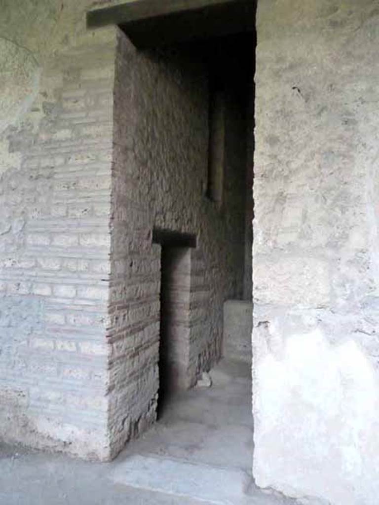 I.15.3 Pompeii. May 2010. Doorway to room 9, kitchen and latrine. South side.