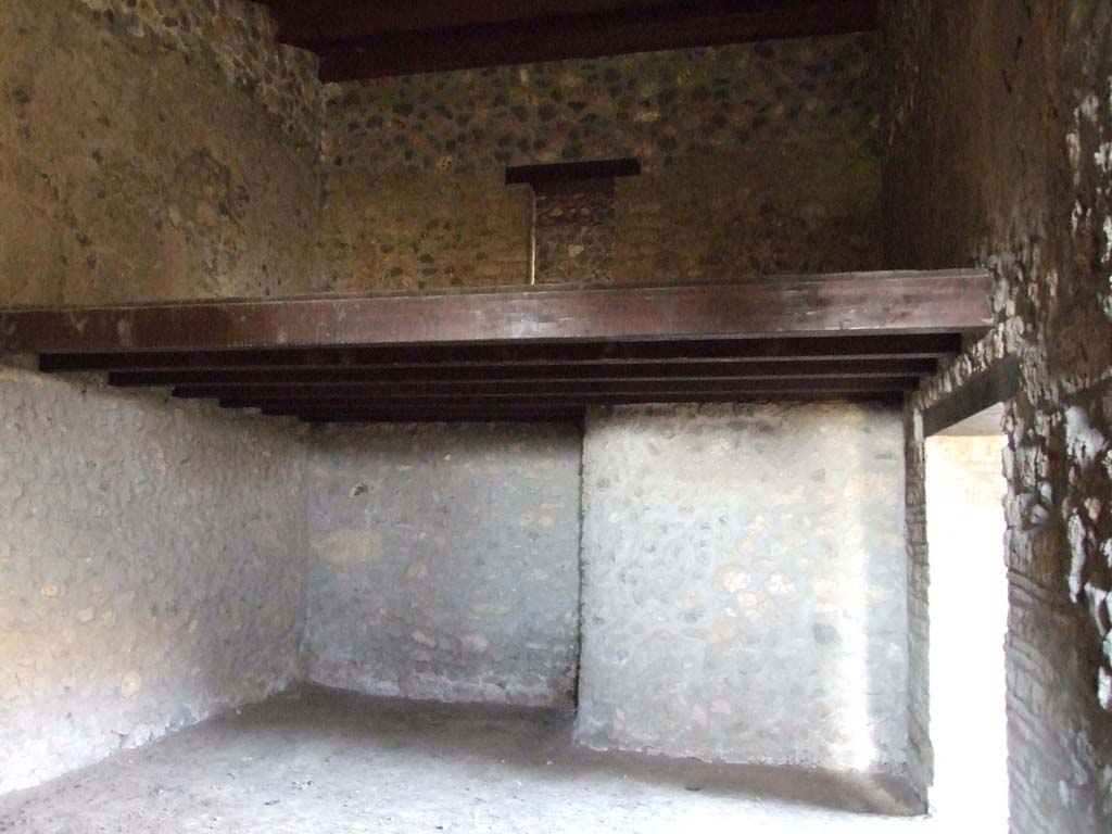 I.15.3 Pompeii. December 2007. Room 11 in south-west corner of peristyle, next to kitchen. 
The stairs in the kitchen, room 9, would have led to the door on the upper floor. Looking north.
