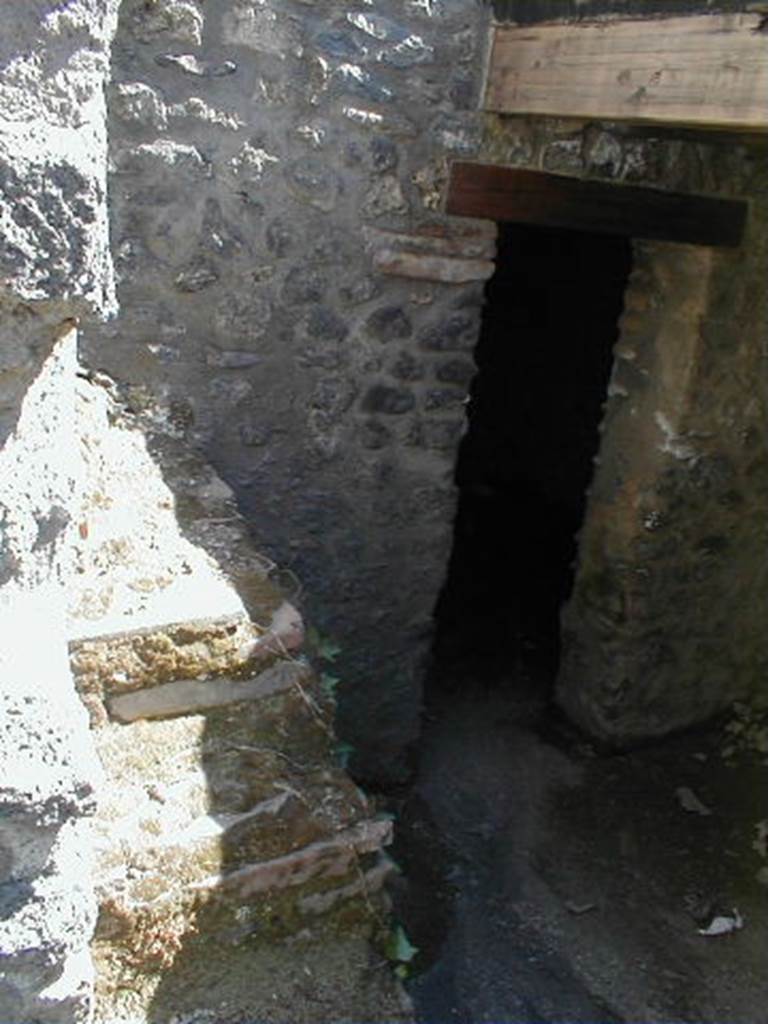 I.15.5 Pompeii. May 2005. Looking south from entrance, towards remains of steps to upper floor and doorway to room in the south.
