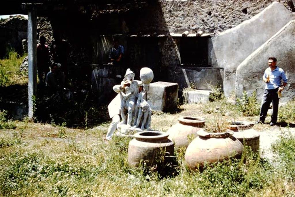 I.20.1 Pompeii. 1961. Looking north-west across garden area towards triclinium, dolia and gladiator - having a drink. Photo by Stanley A. Jashemski.
Source: The Wilhelmina and Stanley A. Jashemski archive in the University of Maryland Library, Special Collections (See collection page) and made available under the Creative Commons Attribution-Non Commercial License v.4. See Licence and use details.
J61f0469
