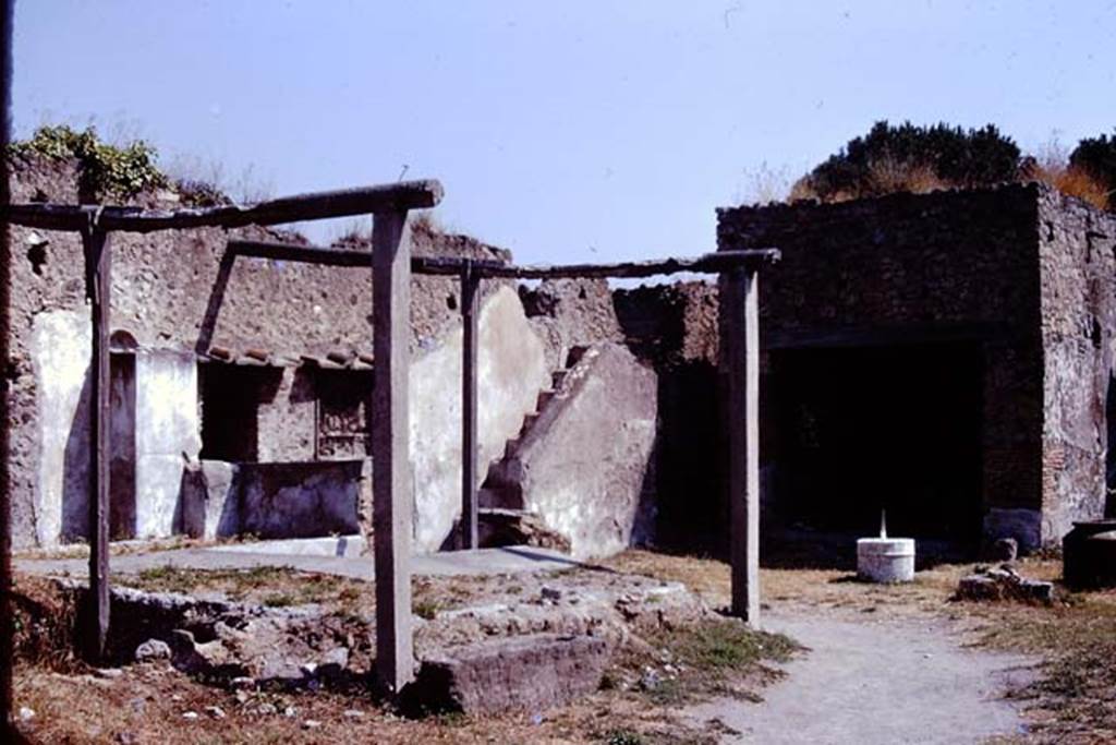 I.20.1 Pompeii. 1974. Looking north-east across triclinium towards steps to upper floor. Photo by Stanley A. Jashemski.   
Source: The Wilhelmina and Stanley A. Jashemski archive in the University of Maryland Library, Special Collections (See collection page) and made available under the Creative Commons Attribution-Non Commercial License v.4. See Licence and use details. J74f0713
