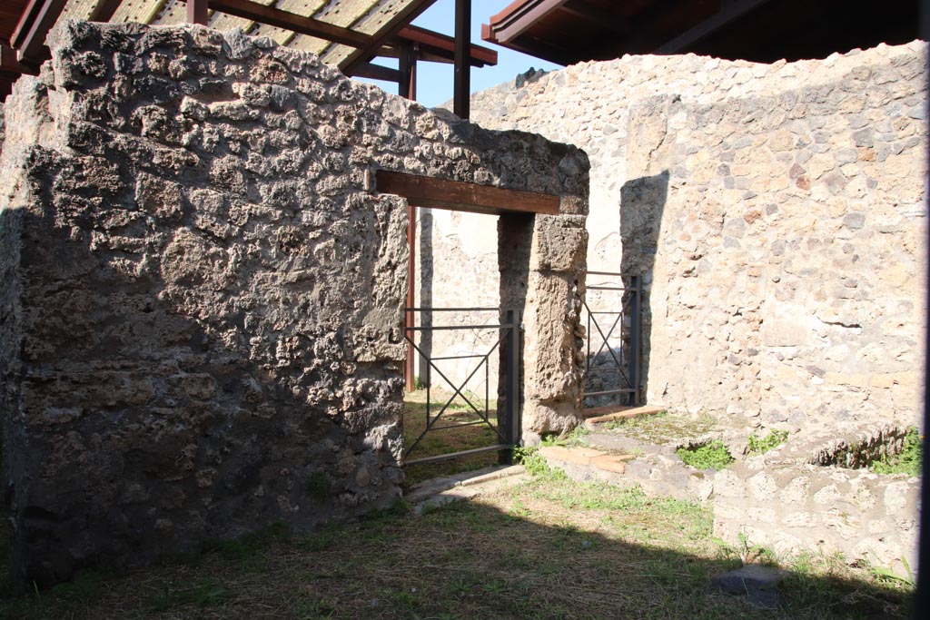 I.20.3 Pompeii October 2022. 
Looking north-west from doorway of I.20.2 towards doorways into rear room of I.20.3. Photo courtesy of Klaus Heese.

