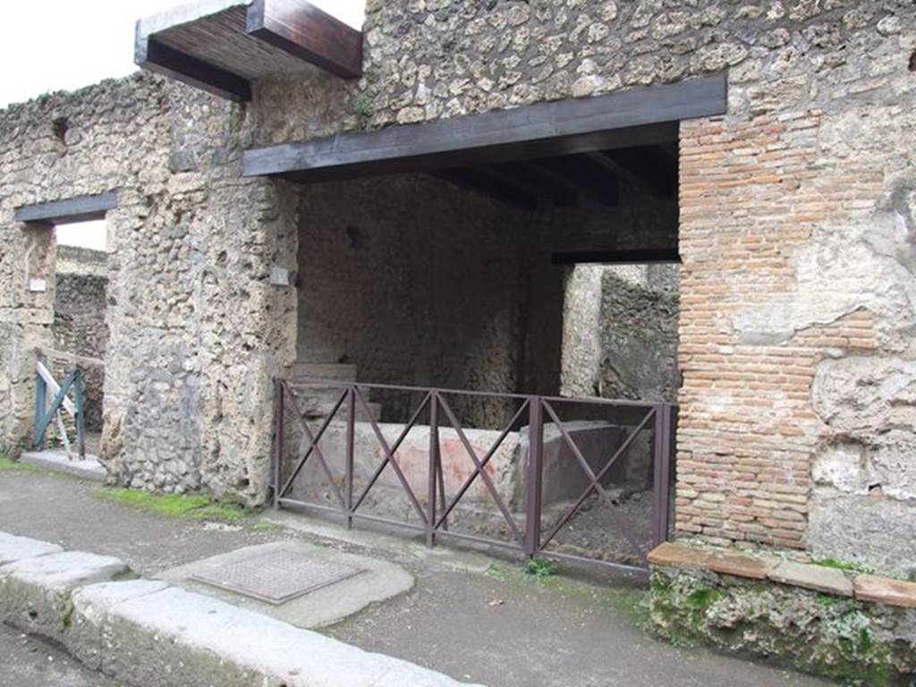 II.1.1 Pompeii. December 2006. Entrance and restored balcony on upper floor. According to Frohlich and Boyce, on the pillars on both sides of the entrance a painting of Hercules on the right, and Mercury on the left were found. Both of these have now faded and been destroyed. 
See Fröhlich, T., 1991. Lararien und Fassadenbilder in den Vesuvstädten. Mainz: von Zabern. (F14) See Boyce G. K., 1937. Corpus of the Lararia of Pompeii. Rome: MAAR 14.  (p.110, no.5 (as II.iv.1)
According to Della Corte, on the left side of the entrance the graffiti recalled the names of the girls working here
Palmyra sitifera     [CIL IV 8475]
[?....]trena culibonia     [CIL IV 8473]
See Della Corte, M., 1965.  Case ed Abitanti di Pompei. Napoli: Fausto Fiorentino. (p. 366)
According to Epigraphik-Datenbank Clauss/Slaby (See www.manfredclauss.de), they read as
Pamhira si[t]ifera     [CIL IV 8475]
]matrona culibonia     [CIL IV 8473]
According to Varone and Stefani, to the left of the entrance, but nearer the entrance II.1.2, the following could be read:
(Pop]idium  Secundum
[aed(ilem)]  Primio  rog(at)     [CIL IV 7495]
See Varone, A. and Stefani, G., 2009. Titulorum Pictorum Pompeianorum, Rome: L’erma di Bretschneider, (p.179)

