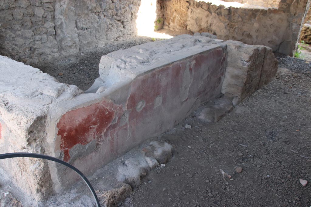 II.1.1 Pompeii. October 2023. Looking south-east towards remains of painted decoration on west side of counter. Photo courtesy of Klaus Heese.