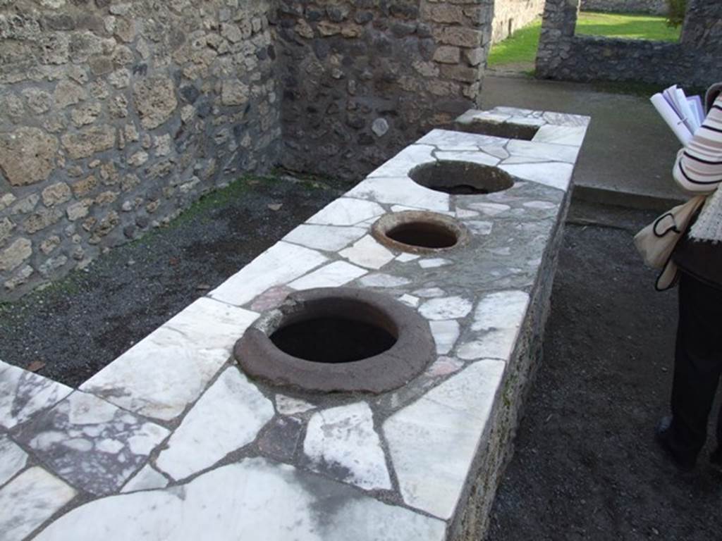 II.1.6 Pompeii. December 2007. Counter with three urns and a hearth.