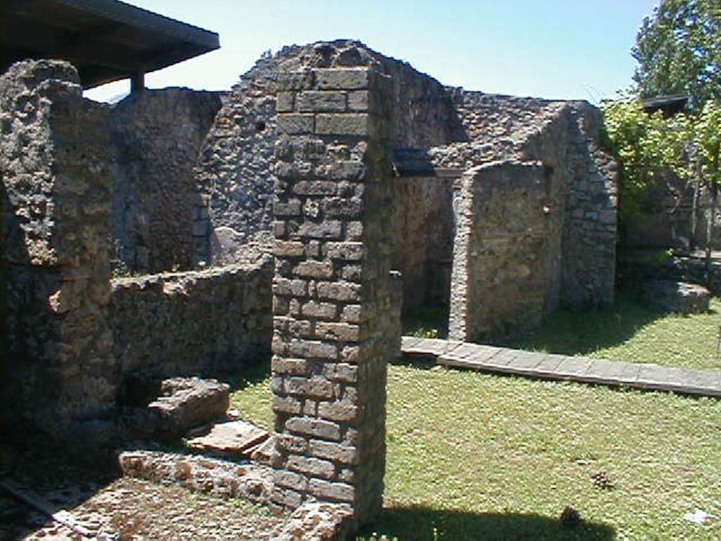 II.1.8 Pompeii. May 2005. Looking north-west from doorway. According to Jashemski, the small room on the left side of the entrance doorway was excavated in 1985. It was found to have a treading floor, where grapes were pressed by foot. The juice flowed into a small dolium. The presence of the treading floor suggested that the garden had been planted in vines to provide grapes for wine that was made on the site. See Jashemski, W. F., 1993. The Gardens of Pompeii, Volume II: Appendices. New York: Caratzas. (p.75)    See II.1.9 for more photos, and that the garden has now been replanted in vines.