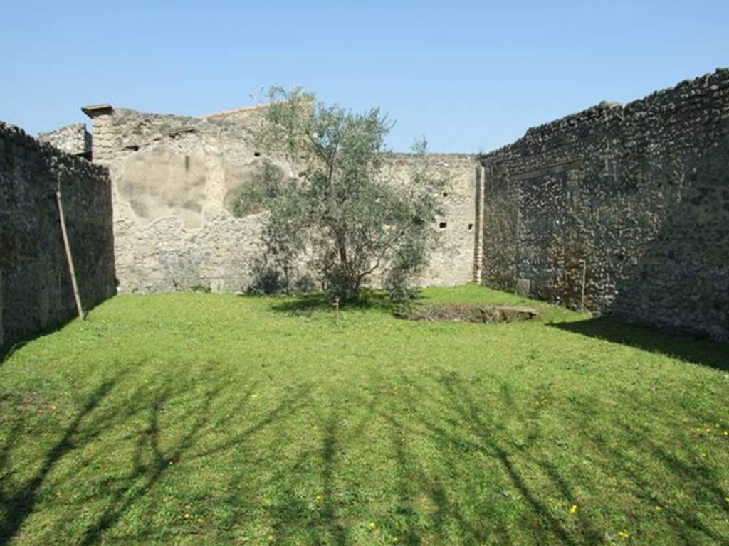 II.1.11 Pompeii. March 2009. Looking north from entrance doorway.
According to Jashemski, she thought the large rectangular area entered directly from the street had been cleared of construction. This was probably done after the earthquake, and was used as a garden. It opened at the rear into two rooms which were part of an industrial complex
See Jashemski, W. F., 1993. The Gardens of Pompeii, Volume II: Appendices. New York: Caratzas. (p.76)
