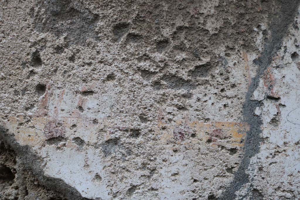 II.1.13 Pompeii. December 2018. 
Detail from painted plaster on exterior wall, on north side (left) of entrance. Photo courtesy of Aude Durand.
