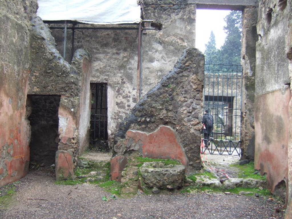 II.2.3 Pompeii. December 2005. South wall, with doorways to small cubiculum, room 3 and atrium of II.2.2. According to Eschebach, near the rear wall are two steps leading to the stairs to upper floor. Under the stairs would have been the cistern mouth. See Eschebach, L., 1993. Gebudeverzeichnis und Stadtplan der antiken Stadt Pompeji. Kln: Bhlau. (p.89)

