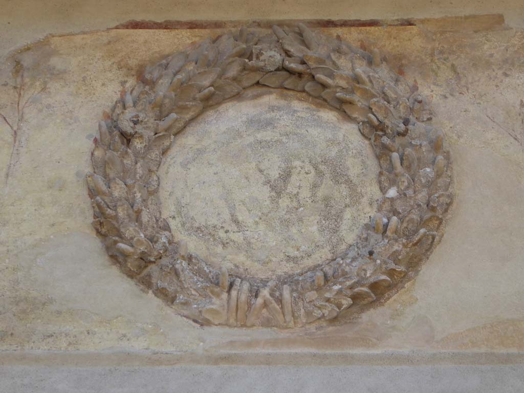 II.2.4 Pompeii. May 2016. Detail of emblem decoration above entrance doorway.
Photo courtesy of Buzz Ferebee.
