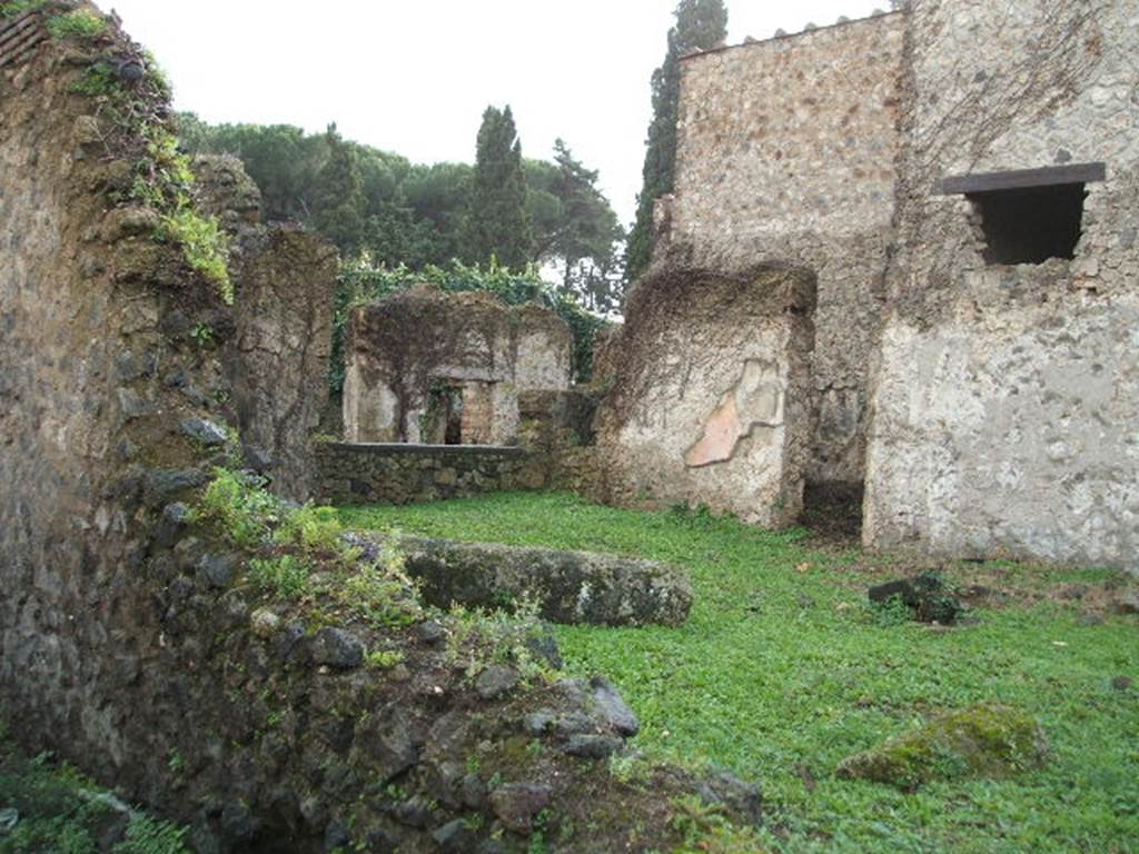 II.3.4 Pompeii. December 2004. Looking south-west from side roadway, towards area of tablinum.