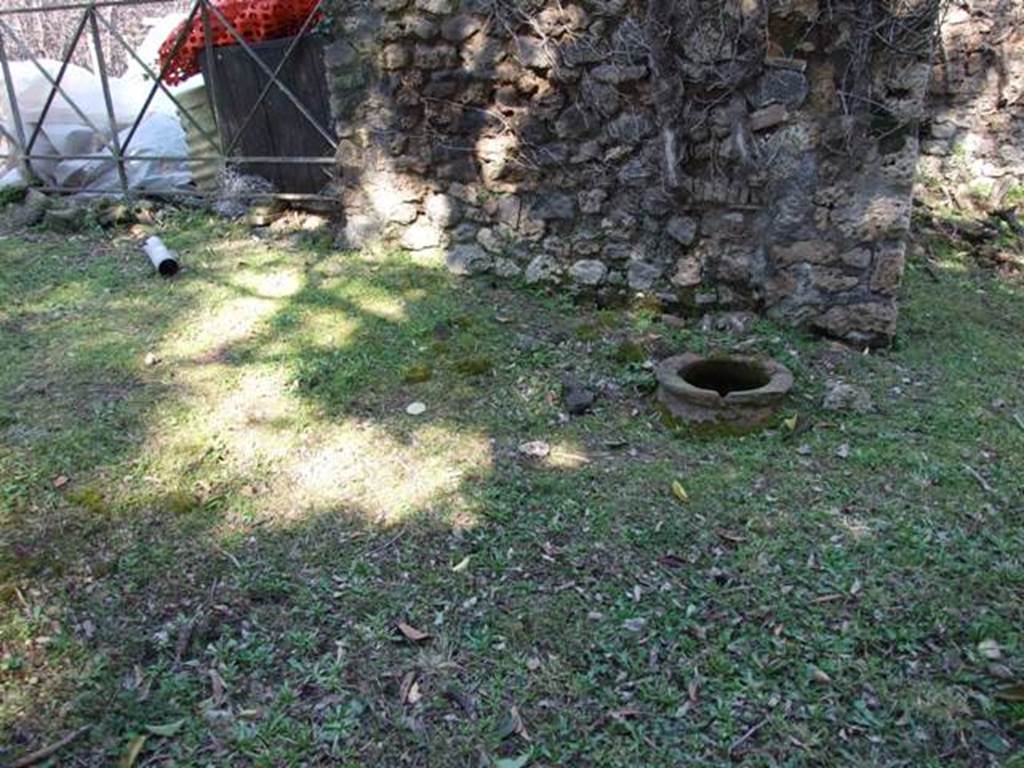 II.3.7 Pompeii. March 2009. Looking north to buried dolium on east side of remains of triclinium in garden area.