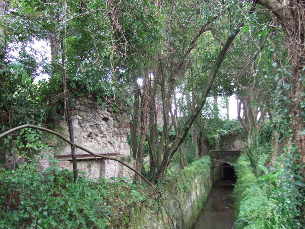 II.3.7 Pompeii. December 2005. Sarno Canal and II.3.8, looking south-west across garden area.