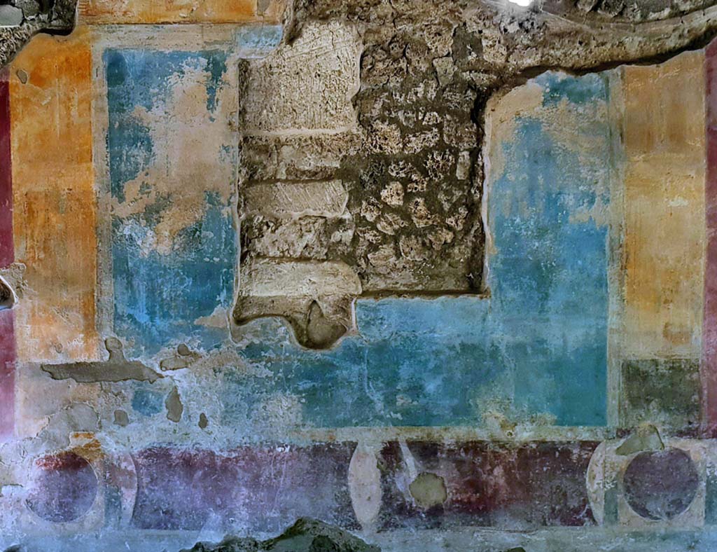 II. 4. 3 Pompeii. August 2012. Atrium, west wall. Fresco in fourth style. Photo courtesy of Davide Peluso.
According to PPM, the painting (m 105 x 113) in the centre of a blue panel was not found at the time of the excavation in the mid 1750’s.
See Carratelli, G. P., 1990-2003. Pompei: Pitture e Mosaici, III. Roma: Istituto della enciclopedia italiana, p. 251. 
