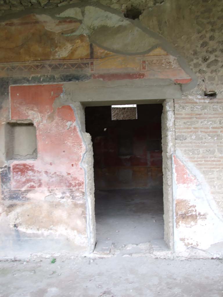 II.4.6 Pompeii. December 2006. Doorway to room at south end of west portico, and wall decoration.