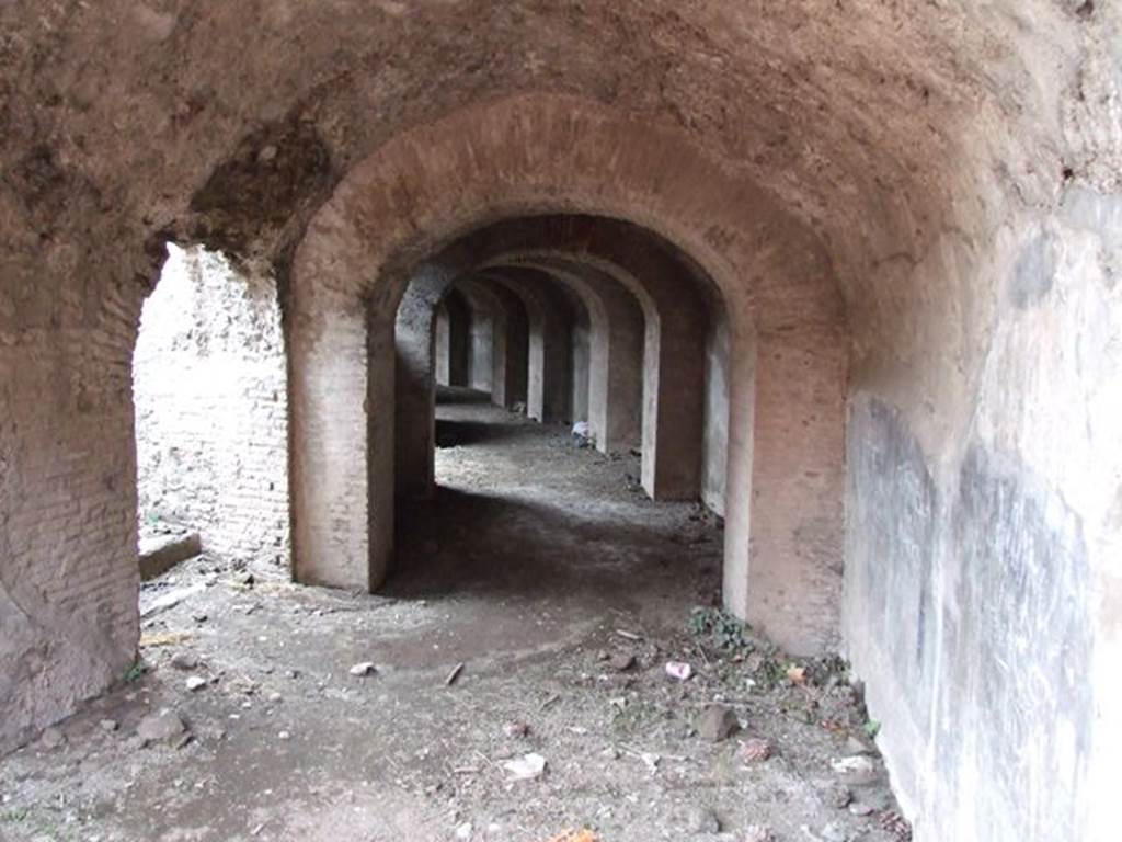 II.6 Pompeii. December 2006. West corridor under Amphitheatre, looking south-west. According to Pagano and Prisciandaro, graffiti were found here, some painted in red and some in black.
Found 24th November 1814 (PAH I, 3,165, III,1) –
Omnia munera vicisti
ton henta theamaton est    [CIL IV 1111 painted in black]
Abdili Eh habes         
te bene                            [CIL IV 1112]
Sabinum                         [CIL IV 1113]
Found 27th November 1814, (PAH I, 3, 165, III,1) painted in red, but hardly readable –
Olio M()
Feliciu
Lyxania
Stephanio
/
Simicrito amor CRINRIN
VAVRIVS                         [CIL IV  1114]
Found 1st December 1814, (PAH I, 3, 166, III,1* - *27th November) painted in red –
Laelius Narcissus occupant    [CIL IV 1115]
Popidium Ruf(um)
A<e=B>dili rei                 [CIL IV 1116]
See Pagano, M. andPrisciandaro, R., 2006. Studio sulle provenienze degli oggetti rinvenuti negli scavi borbonici del regno di Napoli. Naples : Nicola Longobardi. (p.112)
