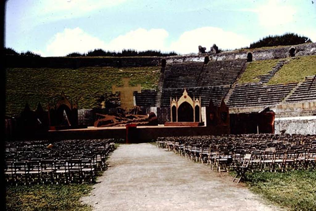 II.6 Pompeii. September 2024. 
Looking west across amphitheatre towards site of preview/rehearsal for a larger event, including Gladiators and Roman Soldiers. 
Photo courtesy of Giuseppe Ciaramella.
