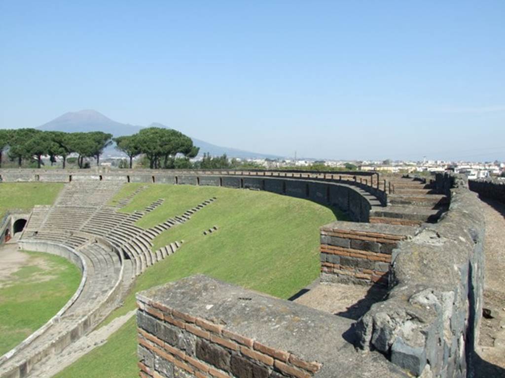 II.6 Pompeii. March 2009. Looking north-east from upper level of the Amphitheatre. The small boxes visible along the upper level, were possibly for women. They were only allowed to have a place in the upper portion of the Amphitheatre. See Mau, A., 1907, translated by Kelsey F. W. Pompeii: Its Life and Art. New York: Macmillan (p.218).