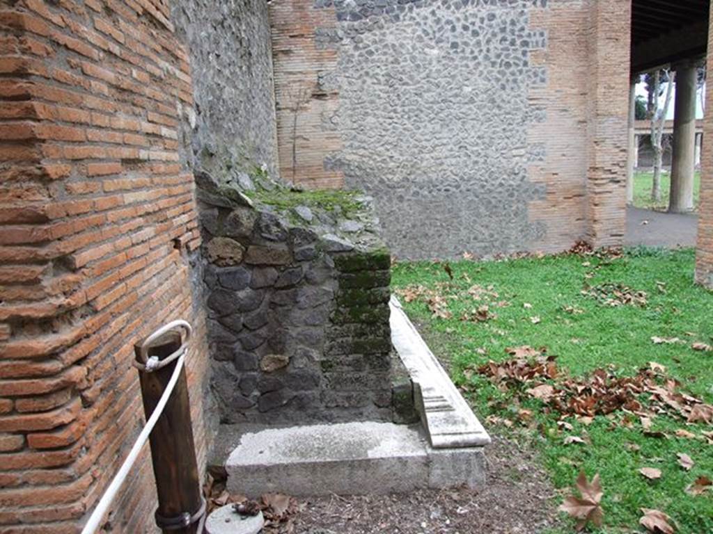 II.7.9a Pompeii. Palaestra. December 2006. Looking north at remains of marble clad base.